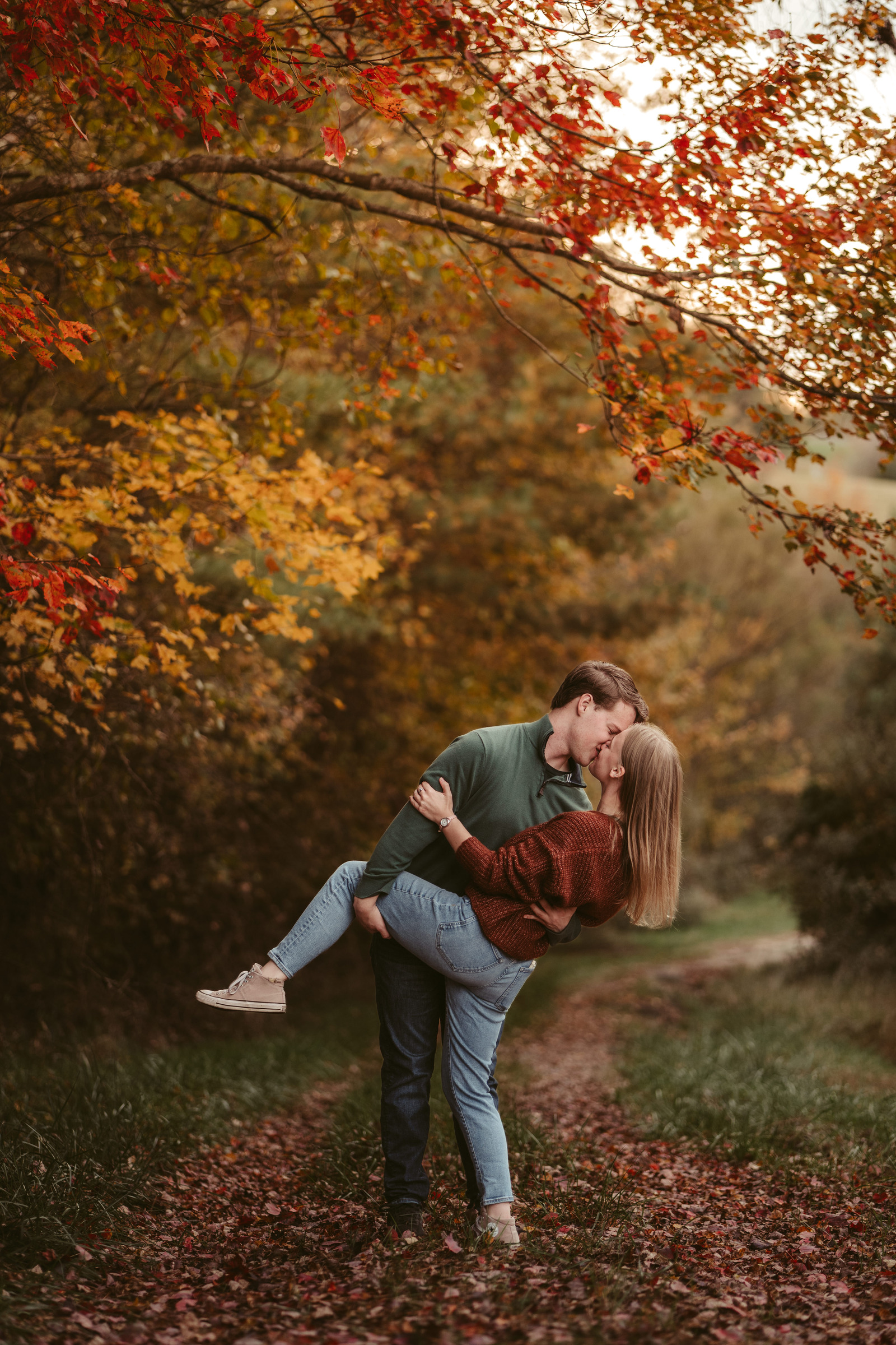 A couple kissing beneath brilliant autumn leaves, Galax Virginia River Songs Photos