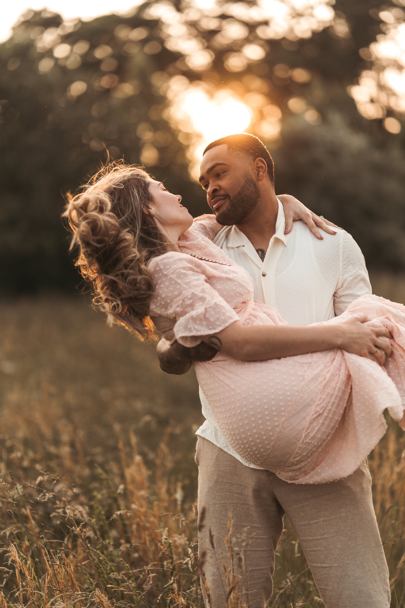 A couple embracing in a sunlit field, couples portrait photo taken in Pearisburg VA